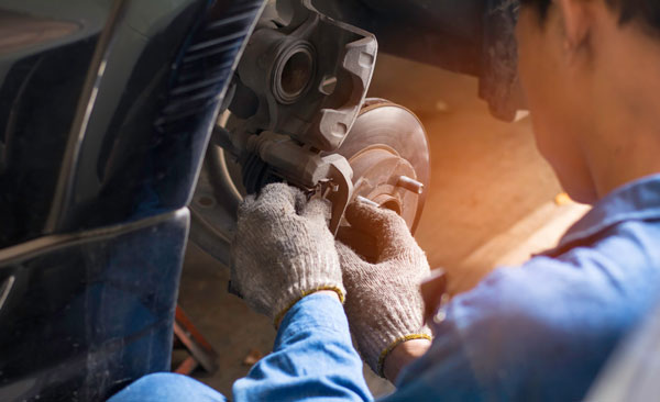 Selective focus disc brake on car, in process of new tire replacement,Car brake repairing in garage