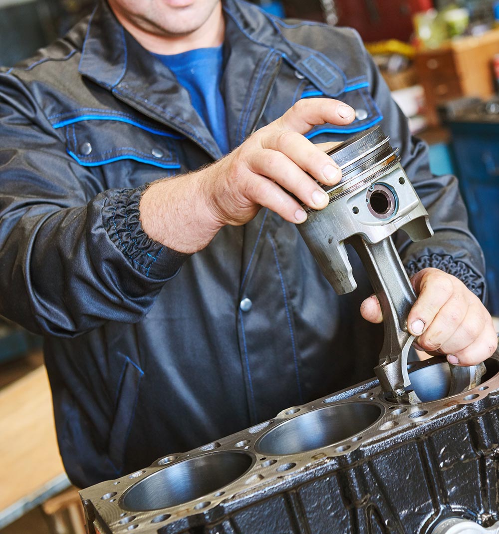 Mechanic holding a machine part