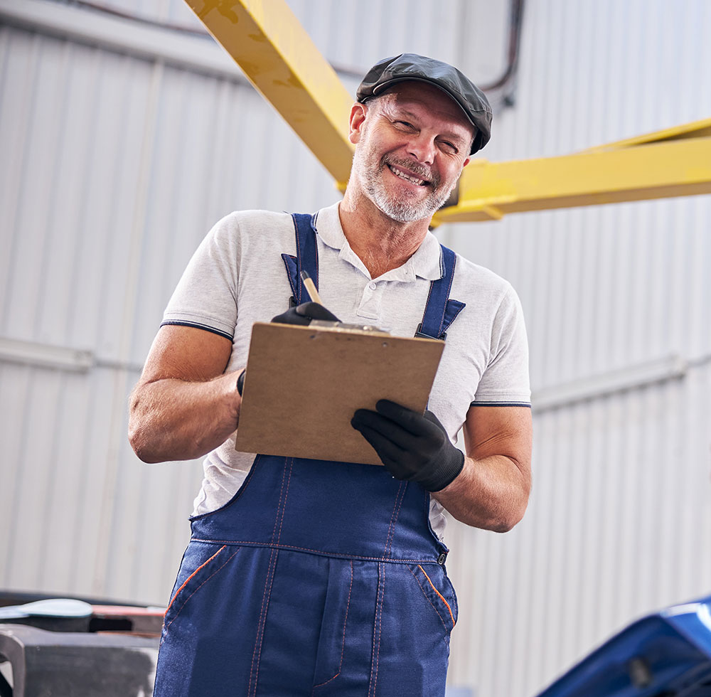 Mechanic holding a clipboard