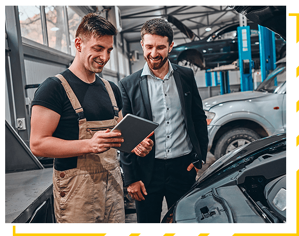 Customer listening to his mechanic at the repair garage