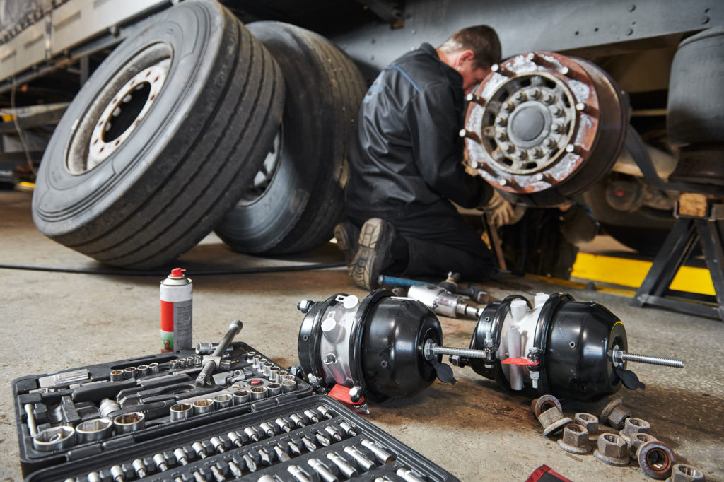 Mechanic working on truck wheels and tire