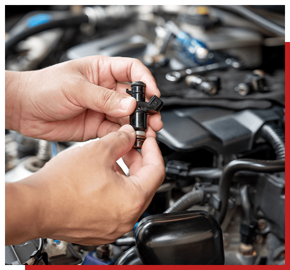 Mechanic holding piece of car engine