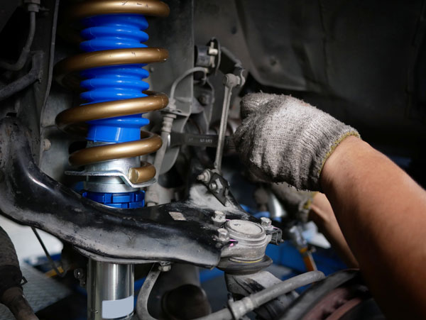 maintaining a car shock absorbers at garage.