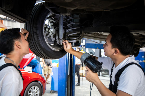 Car mechanic working at automotive service center.