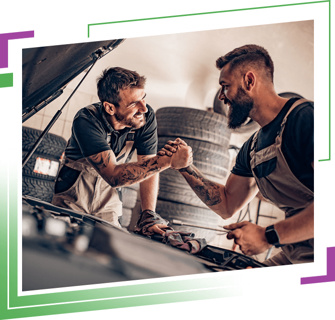 Two mechanics in uniform are working in auto service