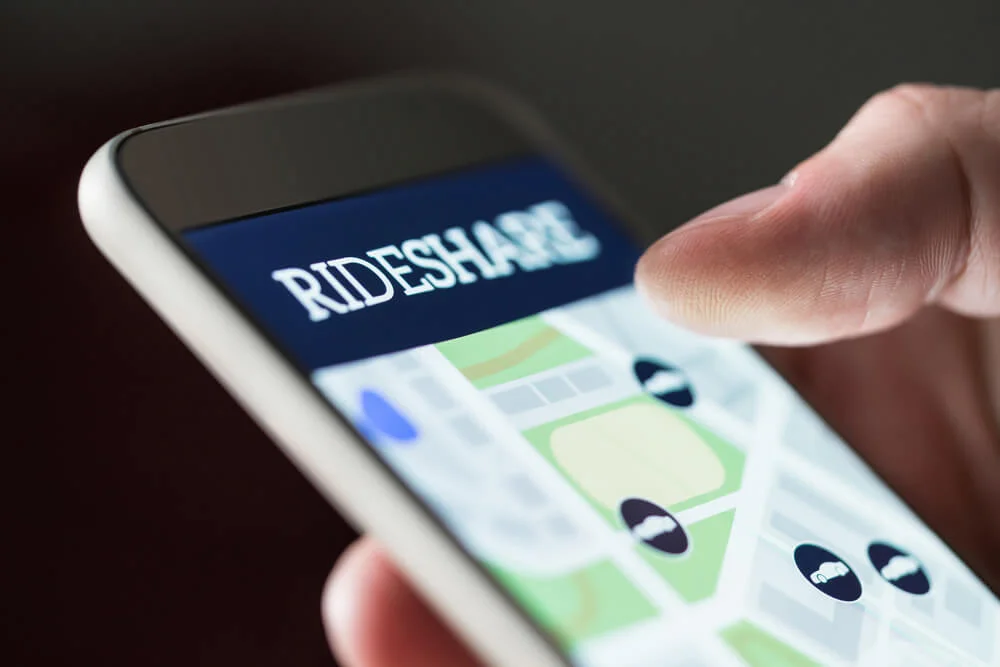 Ride share app in smartphone. Man using rideshare taxi application