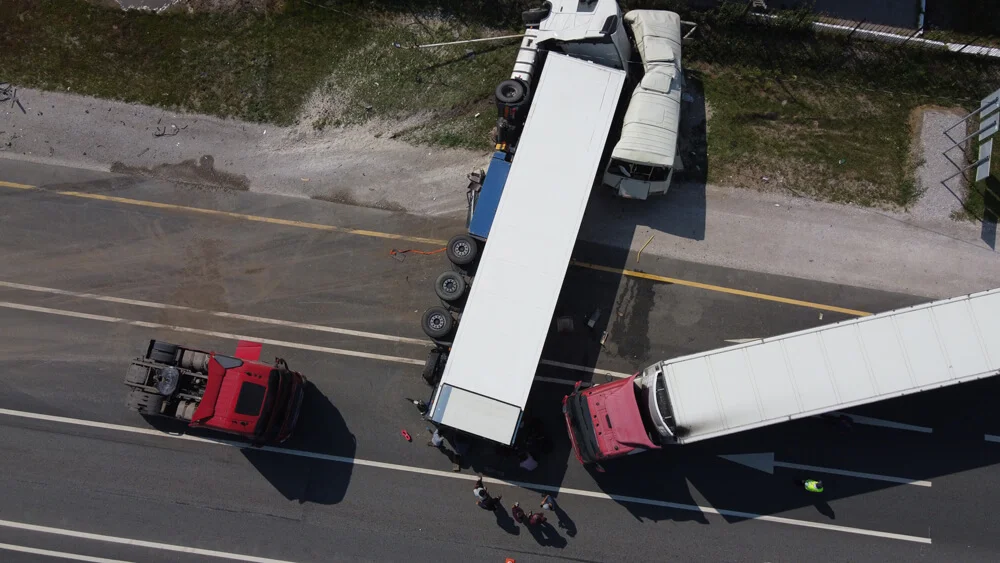 Top view of a car accident involving a truck and a bus. Filming from a drone