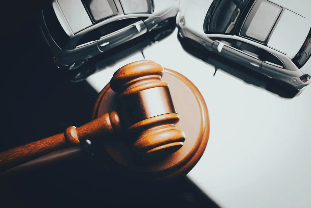 Model of car and gavel. Accident lawsuit or insurance, court case