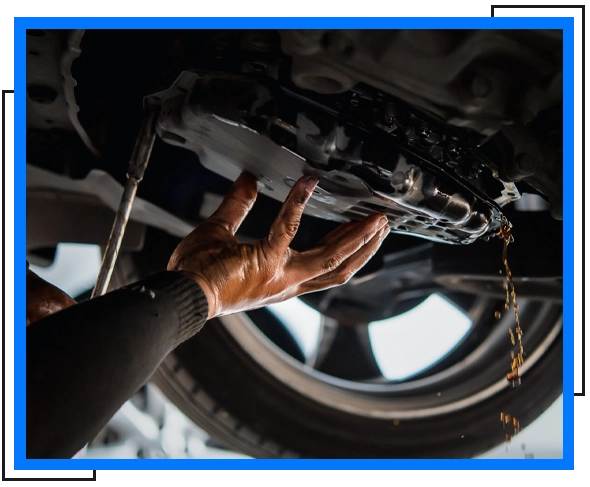 mechanic removing used oil