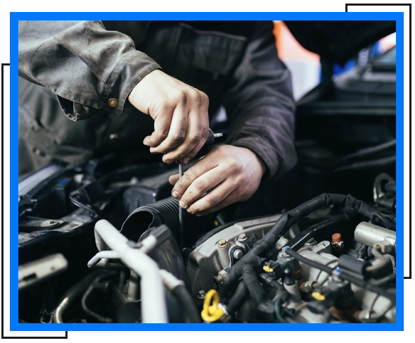 mechanic adjusting some nuts of a car engine