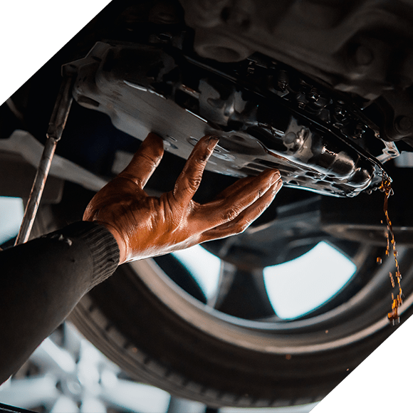 Car mechanic drain the old automatic transmission fluid