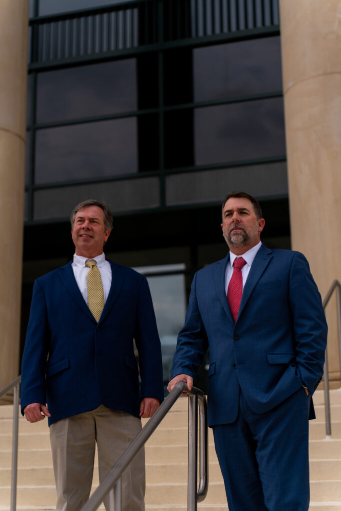 Two men standing in front of a building