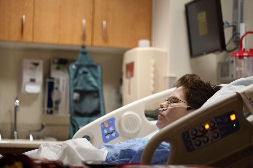 Person laying in hospital bed