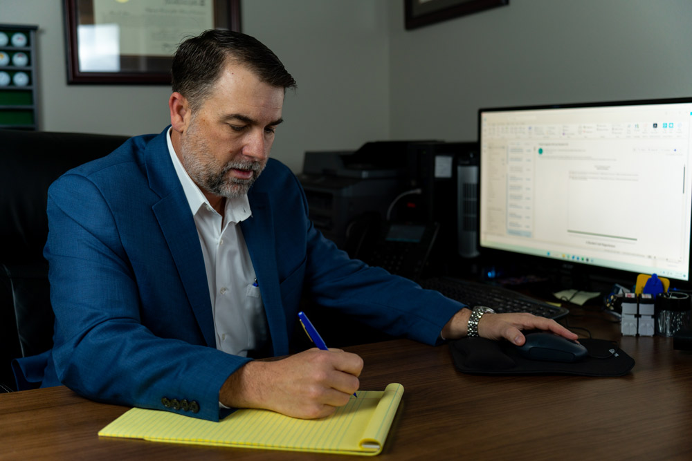 Man writing something down on a notepad