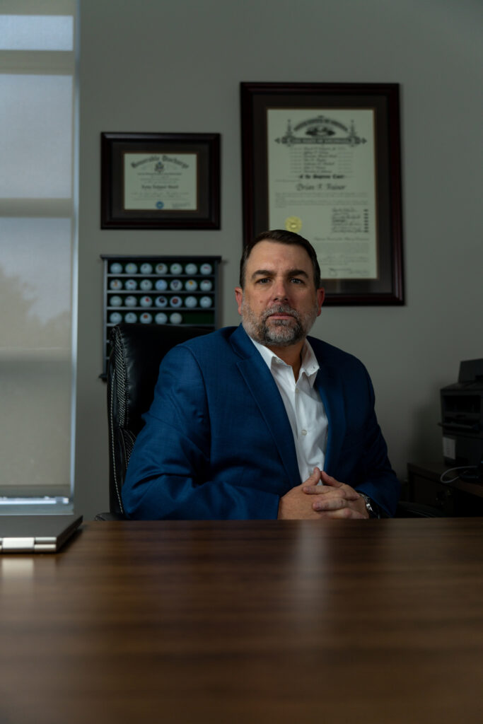 Man in a blue suit sitting on a chair