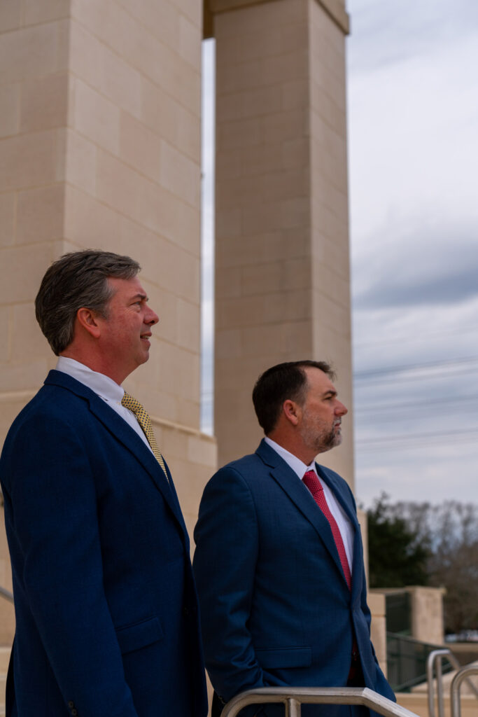 Two men standing in front of a building