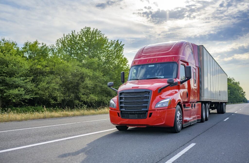 Red truck driving on highway