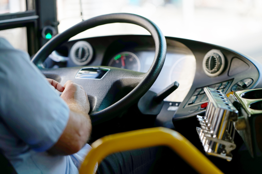 Hands of driver in a modern bus by driving.
