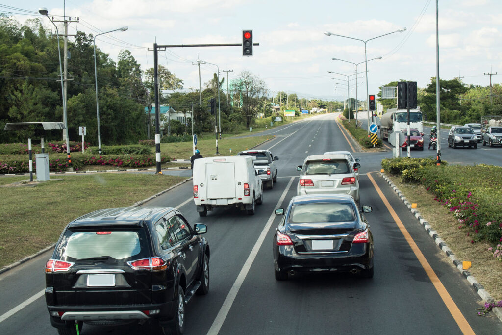 Cars stop red traffic light at the intersection of the Asian Highway