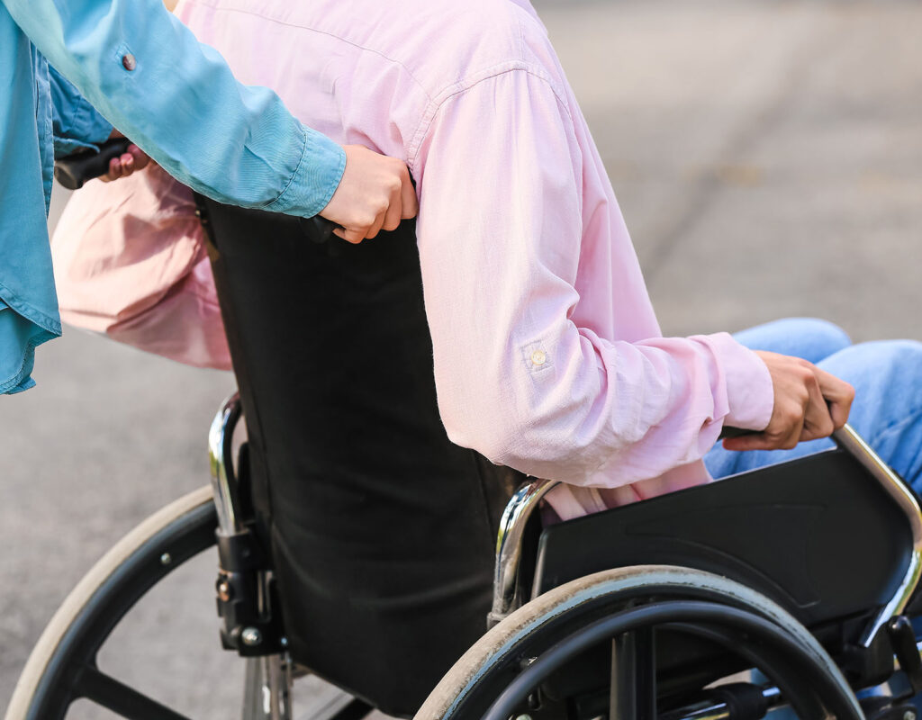 Young man with physical disability and his wife outdoors