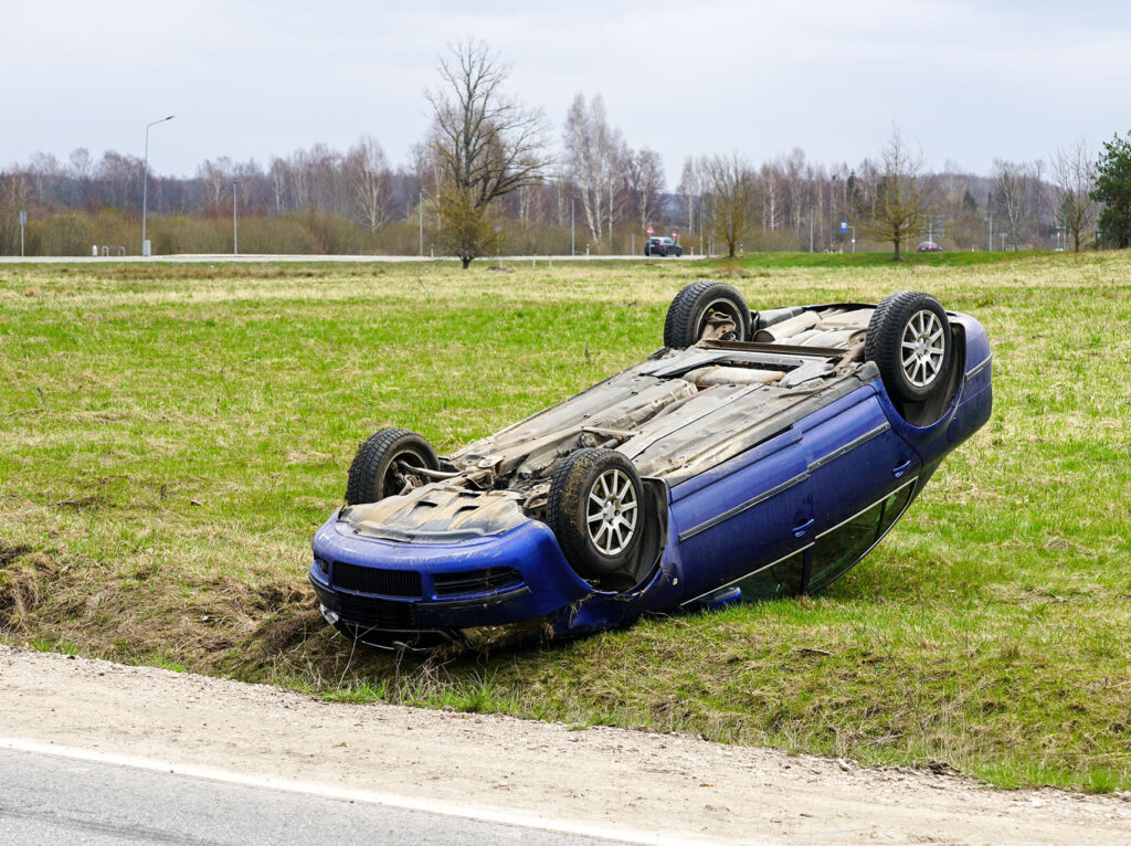 Car accident scene, a passenger car left the road and overturned upside
