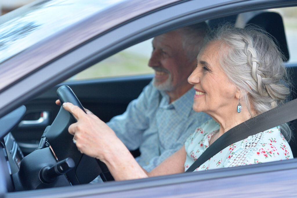 senior couple driving car