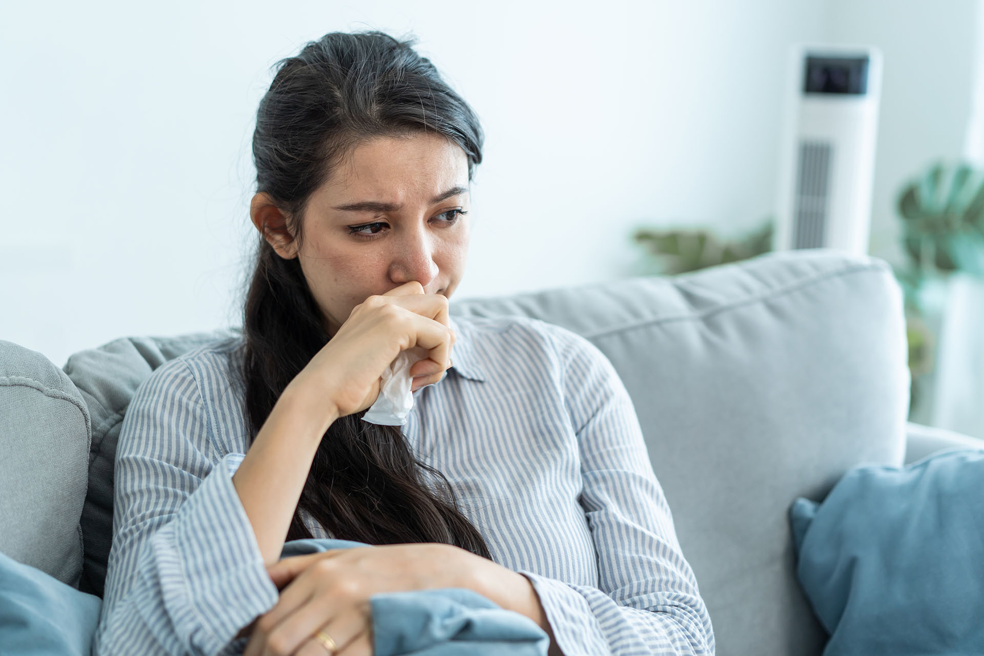 Asian beautiful unhappy woman sit on sofa feel frustrated and stressed