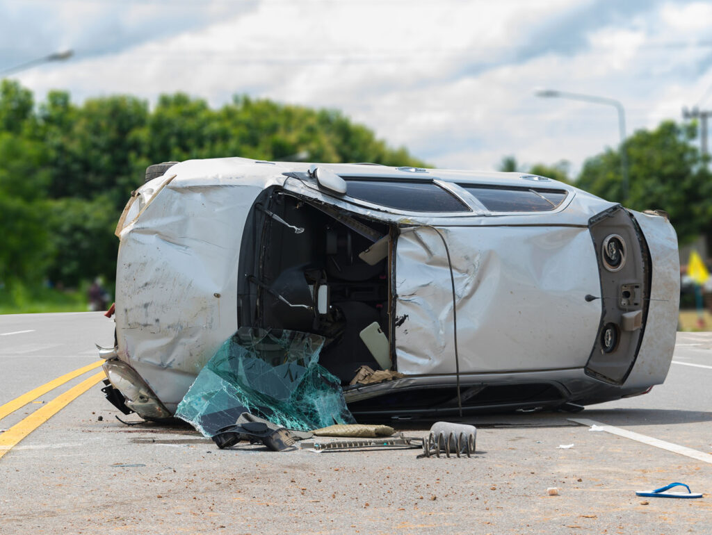 The old car accident scene upside down on the road.