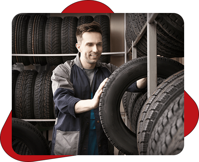 Mechanic holding a car tire