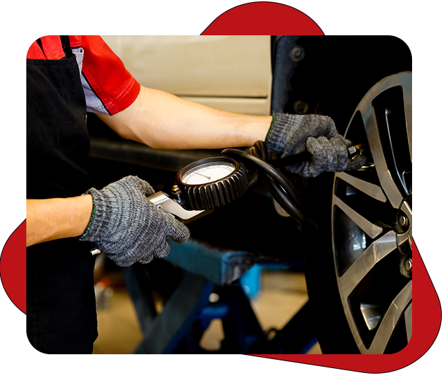 worker car tire pressure check in the auto service garage after change tires