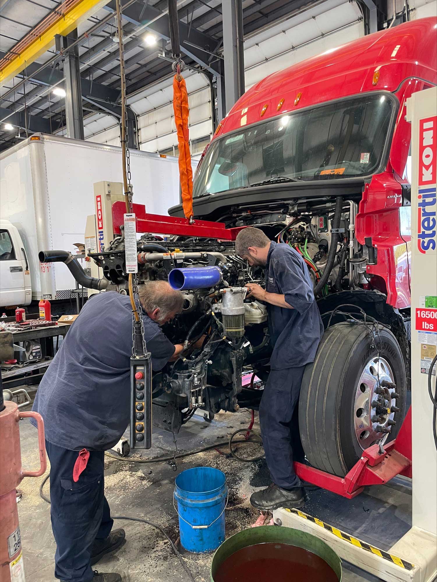 two empoyees repairing truck
