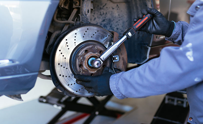 Mechanic Fixing Car Brakes