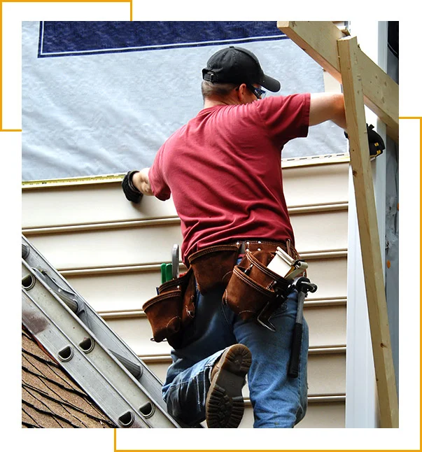 Young home owner remodels his older home by installing siding.