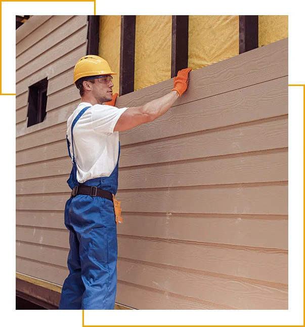 Male worker building house at construction site